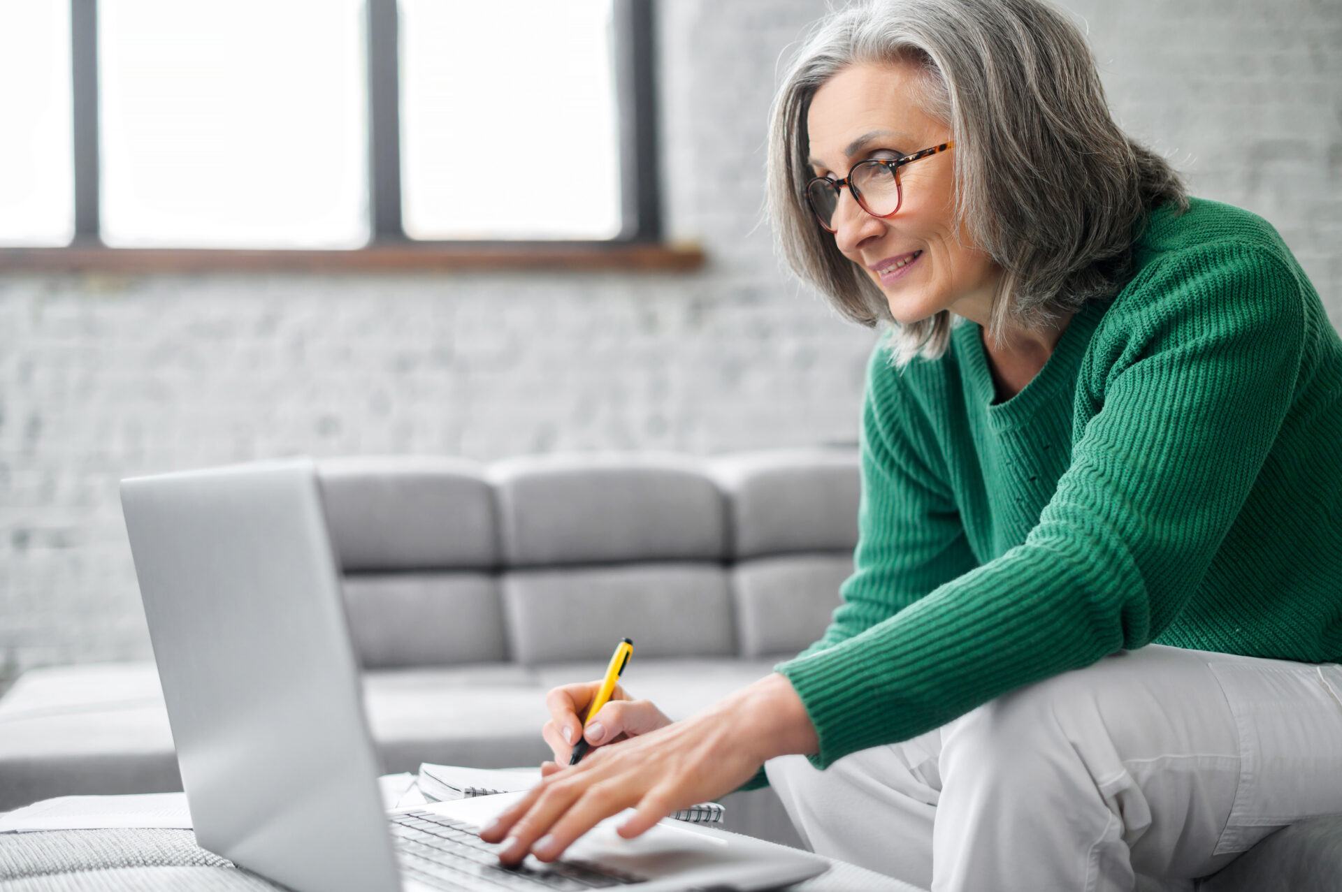 Mature senior woman using a laptop at home
